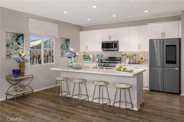 9031 Carson Ave, Hesperia, CA 92344 - kitchen with stainless steel appliances, white cabinetry, decorative backsplash, light countertops, and recessed lighting