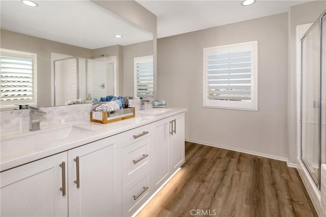 9031 Carson Ave, Hesperia, CA 92344 - bathroom featuring a shower stall, healthy amount of natural light, wood finished floors, double vanity, and recessed lighting