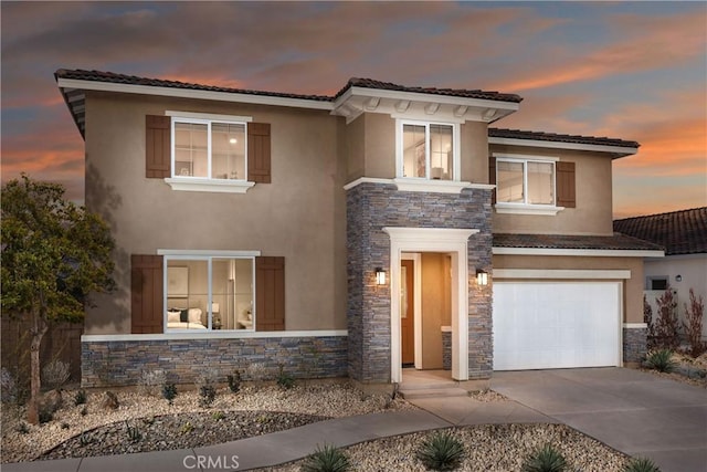 9031 Carson Ave, Hesperia, CA 92344 - view of front facade featuring stone siding, stucco siding, a garage, and driveway