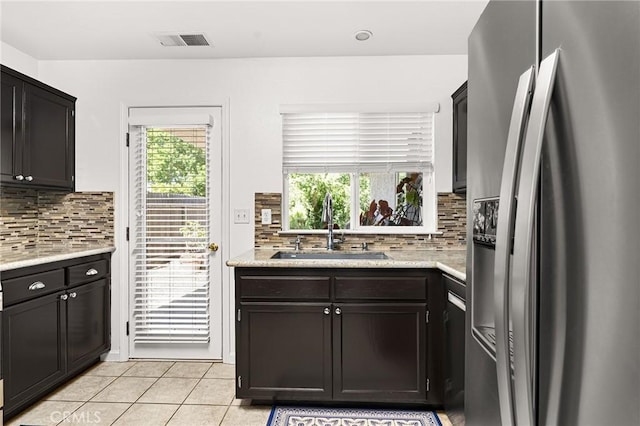 1 Alden Ct, Chico, CA 95973 - kitchen featuring stainless steel refrigerator with ice dispenser, light tile patterned floors, and tasteful backsplash