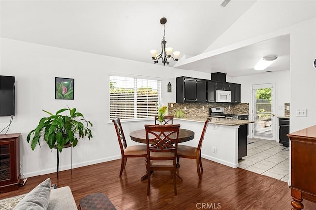 1 Alden Ct, Chico, CA 95973 - dining space featuring a chandelier, lofted ceiling, and wood finished floors