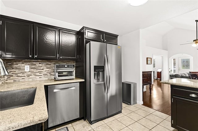 1 Alden Ct, Chico, CA 95973 - kitchen featuring appliances with stainless steel finishes, dark cabinets, light tile patterned floors, backsplash, and light countertops