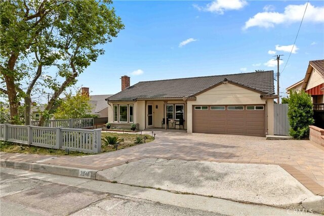 3348 Burritt Way, La Crescenta, CA 91214 - view of front facade featuring a tile roof, an attached garage, a chimney, and driveway