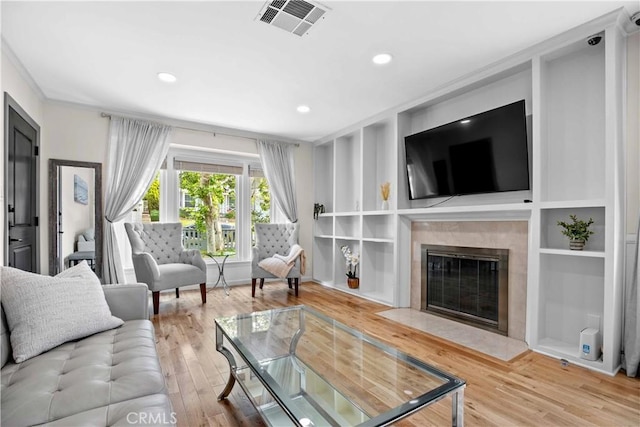 3348 Burritt Way, La Crescenta, CA 91214 - living room with wood finished floors, a high end fireplace, built in shelves, recessed lighting, and crown molding