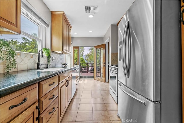 3348 Burritt Way, La Crescenta, CA 91214 - kitchen featuring stainless steel appliances, tasteful backsplash, recessed lighting, light tile patterned floors, and brown cabinetry