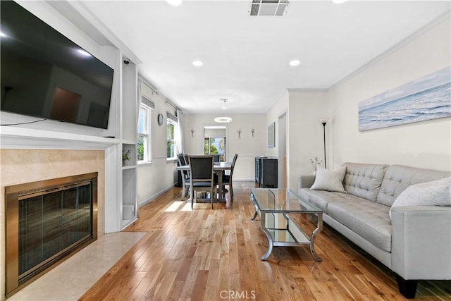 3348 Burritt Way, La Crescenta, CA 91214 - living area with light wood finished floors, recessed lighting, a fireplace, and crown molding