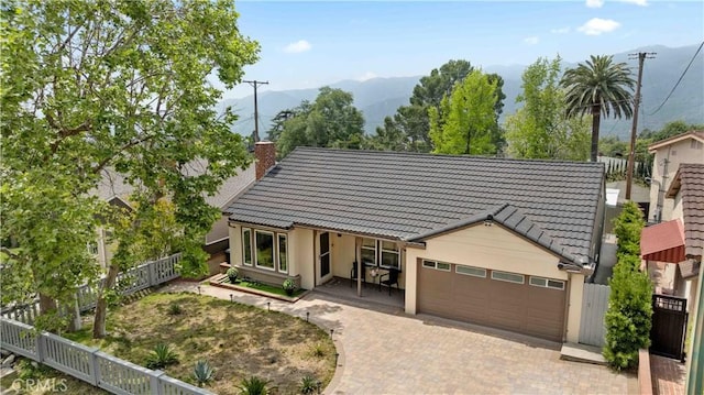 3348 Burritt Way, La Crescenta, CA 91214 - view of front of house featuring a tile roof, a garage, decorative driveway, a chimney, and stucco siding