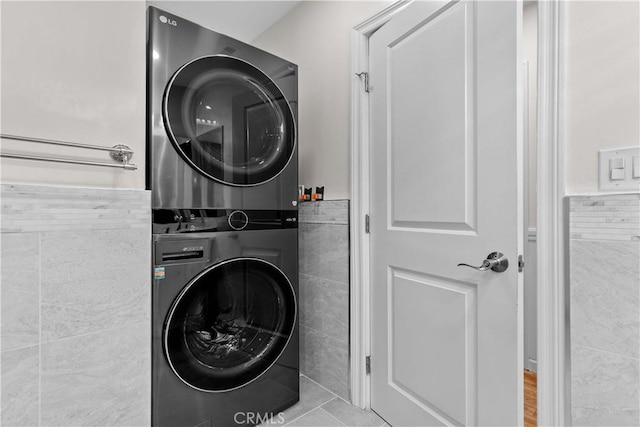 3348 Burritt Way, La Crescenta, CA 91214 - laundry room featuring stacked washer / dryer and tile walls