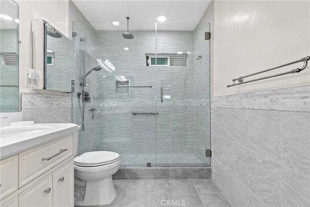 3348 Burritt Way, La Crescenta, CA 91214 - bathroom featuring tile walls, vanity, a stall shower, tile patterned floors, and recessed lighting