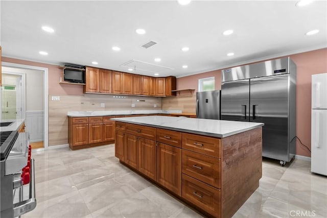 3348 Burritt Way, La Crescenta, CA 91214 - kitchen with open shelves, stainless steel built in refrigerator, freestanding refrigerator, brown cabinets, and a kitchen island