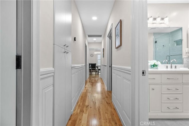 3348 Burritt Way, La Crescenta, CA 91214 - hallway with a decorative wall, light wood-style floors, and a wainscoted wall