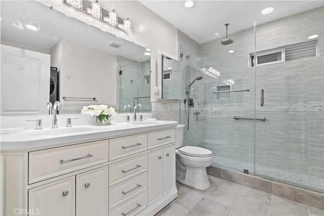 3348 Burritt Way, La Crescenta, CA 91214 - bathroom featuring double vanity, a stall shower, tile patterned flooring, stacked washer / drying machine, and recessed lighting