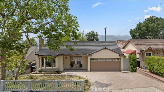 3348 Burritt Way, La Crescenta, CA 91214 - view of front of house with a tiled roof, an attached garage, a chimney, decorative driveway, and stucco siding