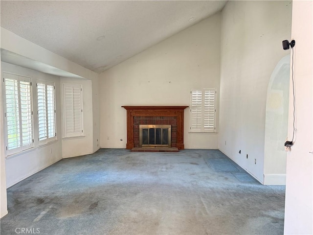 23020 Jensen Ct, Grand Terrace, CA 92313 - unfurnished living room featuring vaulted ceiling, carpet, and a brick fireplace