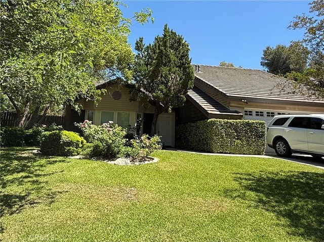 23020 Jensen Ct, Grand Terrace, CA 92313 - view of front of house with a garage, a front lawn, and a tile roof