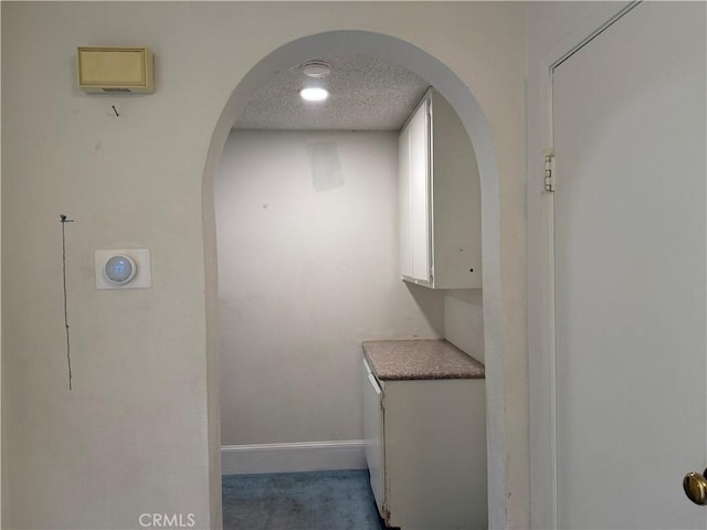 23020 Jensen Ct, Grand Terrace, CA 92313 - hall with arched walkways, a textured ceiling, and carpet flooring