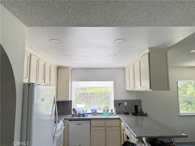 23020 Jensen Ct, Grand Terrace, CA 92313 - kitchen with white appliances, a textured ceiling, tasteful backsplash, and recessed lighting