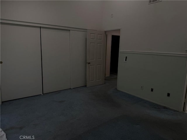 23020 Jensen Ct, Grand Terrace, CA 92313 - unfurnished bedroom with carpet floors, a closet, and a towering ceiling