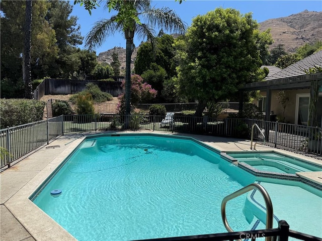 23020 Jensen Ct, Grand Terrace, CA 92313 - view of swimming pool featuring a mountain view, a pool with connected hot tub, and a patio area
