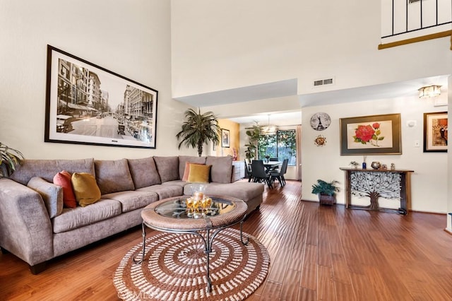 7826 Winnetka Ave, Winnetka, CA 91306 - living area featuring a chandelier, wood finished floors, and a towering ceiling