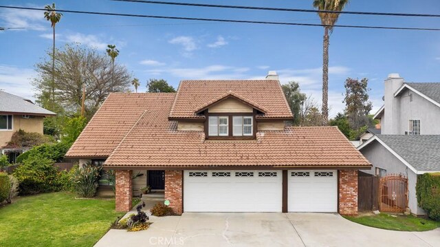 7826 Winnetka Ave, Winnetka, CA 91306 - traditional home featuring a tiled roof, driveway, brick siding, and an attached garage
