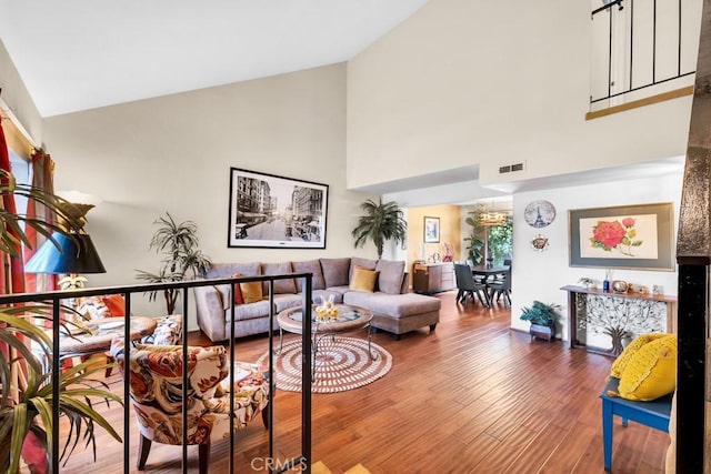 7826 Winnetka Ave, Winnetka, CA 91306 - living area featuring high vaulted ceiling, wood finished floors, and a chandelier