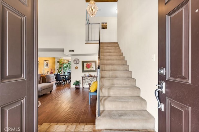 7826 Winnetka Ave, Winnetka, CA 91306 - entrance foyer with stairs, a high ceiling, and wood finished floors