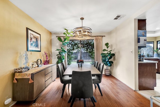 7826 Winnetka Ave, Winnetka, CA 91306 - dining space with light wood-style flooring and a chandelier