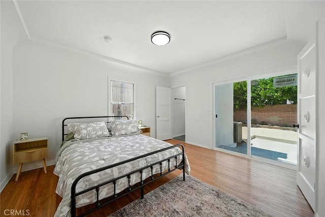 1123 W 81st St, Los Angeles, CA 90044 - bedroom featuring access to outside, wood finished floors, and a spacious closet