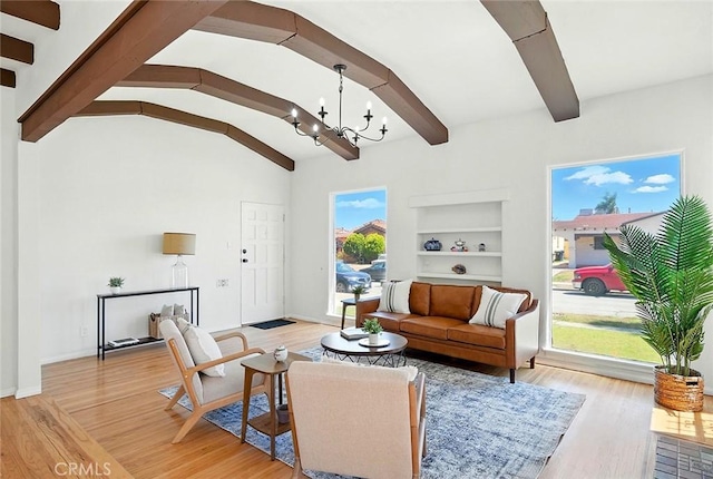 1123 W 81st St, Los Angeles, CA 90044 - living room with a chandelier, light wood finished floors, and built in shelves