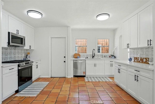 1123 W 81st St, Los Angeles, CA 90044 - kitchen with appliances with stainless steel finishes, tasteful backsplash, and light countertops