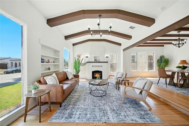 1123 W 81st St, Los Angeles, CA 90044 - living area with a chandelier, built in features, and plenty of natural light