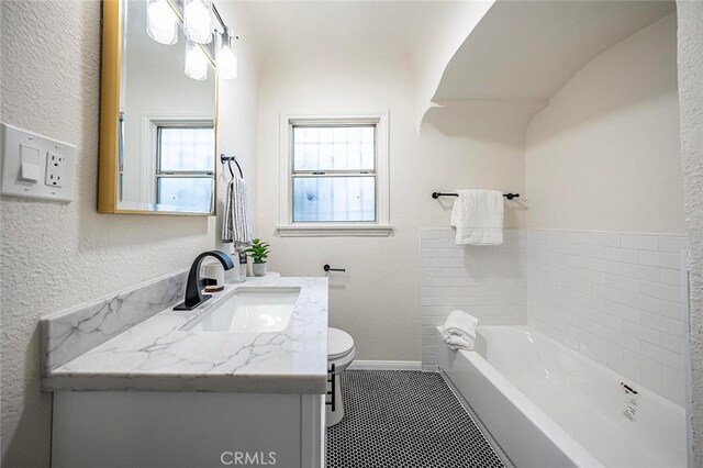 1123 W 81st St, Los Angeles, CA 90044 - bathroom with vanity, a bath, a textured wall, and tile patterned flooring