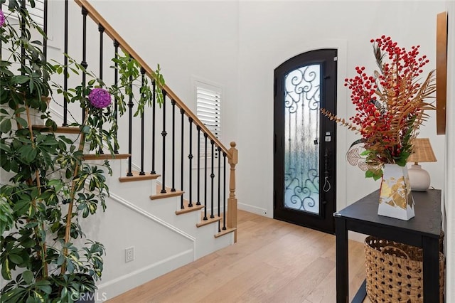 10413 Saint Anna Pl, Fountain Valley, CA 92708 - foyer entrance featuring wood finished floors, arched walkways, and stairway