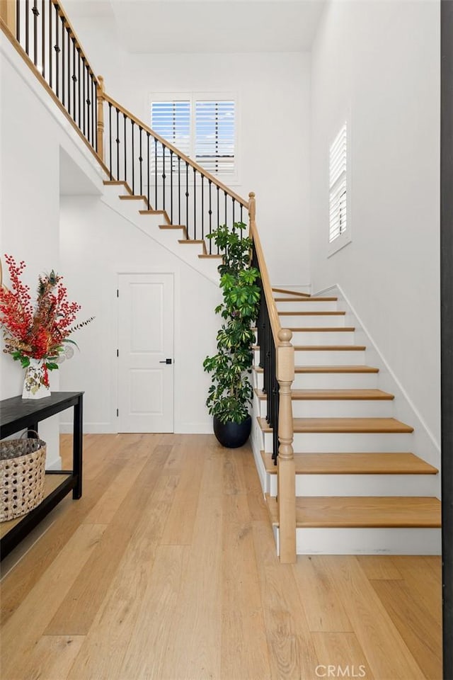 10413 Saint Anna Pl, Fountain Valley, CA 92708 - stairway featuring wood finished floors, healthy amount of natural light, and a high ceiling