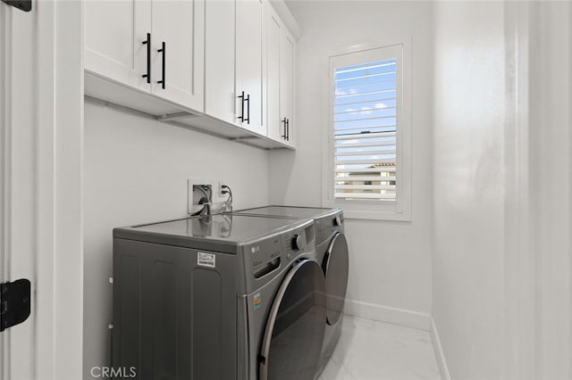 10413 Saint Anna Pl, Fountain Valley, CA 92708 - laundry area with cabinet space, washer and clothes dryer, and marble finish floors