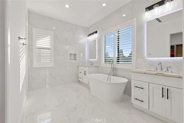 10413 Saint Anna Pl, Fountain Valley, CA 92708 - full bathroom with marble tiled flooring, two vanities, a freestanding bath, and recessed lighting