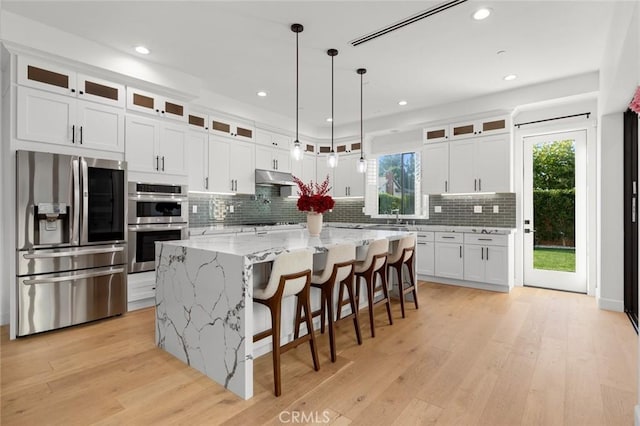 10413 Saint Anna Pl, Fountain Valley, CA 92708 - kitchen featuring stainless steel appliances, decorative backsplash, white cabinets, a center island, and recessed lighting