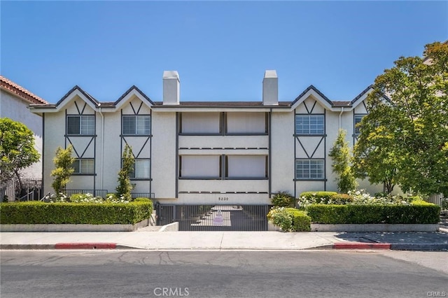5230 Zelzah Ave Unit 3, Encino, CA 91316 - view of property with stucco siding and a chimney