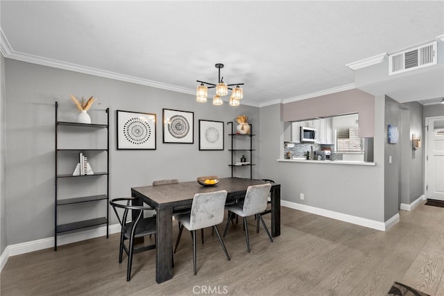 5230 Zelzah Ave Unit 3, Encino, CA 91316 - dining area with wood finished floors, crown molding, and a chandelier