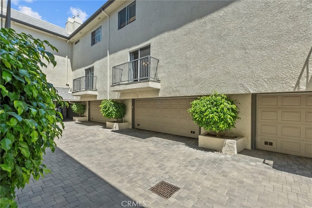 5230 Zelzah Ave Unit 3, Encino, CA 91316 - view of home's exterior with stucco siding, a balcony, and a garage