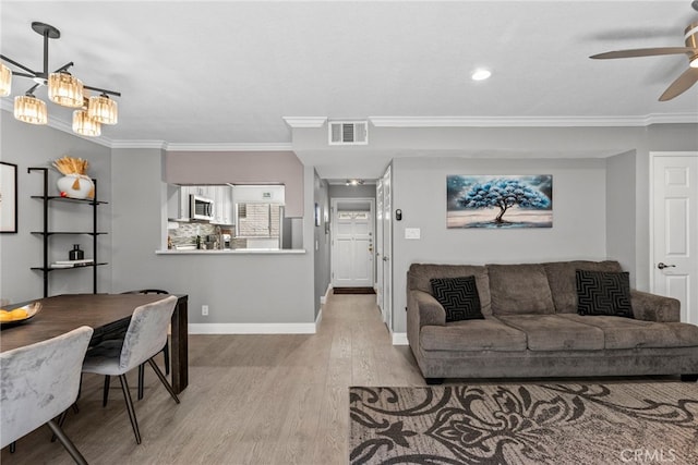 5230 Zelzah Ave Unit 3, Encino, CA 91316 - living area featuring light wood-type flooring, a ceiling fan, ornamental molding, and a chandelier
