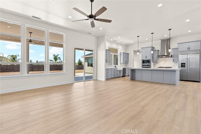 5035 San Juanico Dr, Chico, CA 95973 - kitchen with built in appliances, gray cabinetry, wall chimney exhaust hood, ceiling fan, and recessed lighting