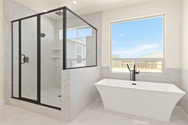 5035 San Juanico Dr, Chico, CA 95973 - full bath with marble tiled flooring, a freestanding bath, a marble finish shower, and tile walls