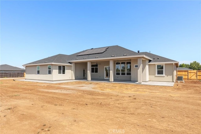 5035 San Juanico Dr, Chico, CA 95973 - back of property with a patio area, roof mounted solar panels, stucco siding, and ceiling fan