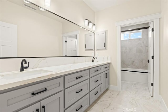 5035 San Juanico Dr, Chico, CA 95973 - bathroom with double vanity, marble finish flooring, and bath / shower combo with glass door