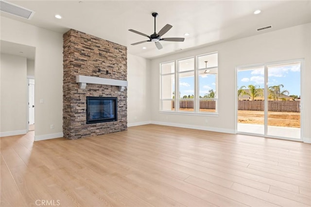5035 San Juanico Dr, Chico, CA 95973 - unfurnished living room featuring ceiling fan, light wood-type flooring, a stone fireplace, and recessed lighting