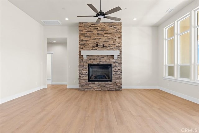 5035 San Juanico Dr, Chico, CA 95973 - unfurnished living room featuring light wood-type flooring, ceiling fan, plenty of natural light, a stone fireplace, and recessed lighting