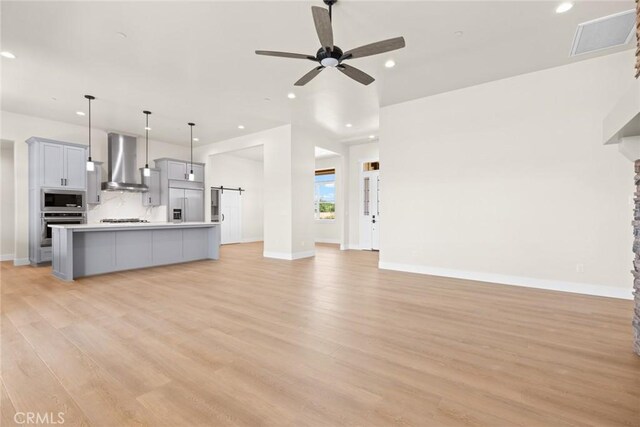 5035 San Juanico Dr, Chico, CA 95973 - unfurnished living room with light wood finished floors, a ceiling fan, and recessed lighting
