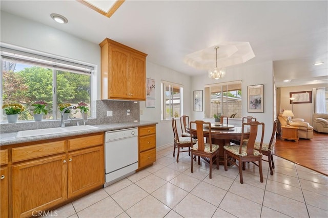 5939 N Vista St, San Gabriel, CA 91775 - kitchen with white dishwasher, a chandelier, light tile patterned floors, backsplash, and light countertops